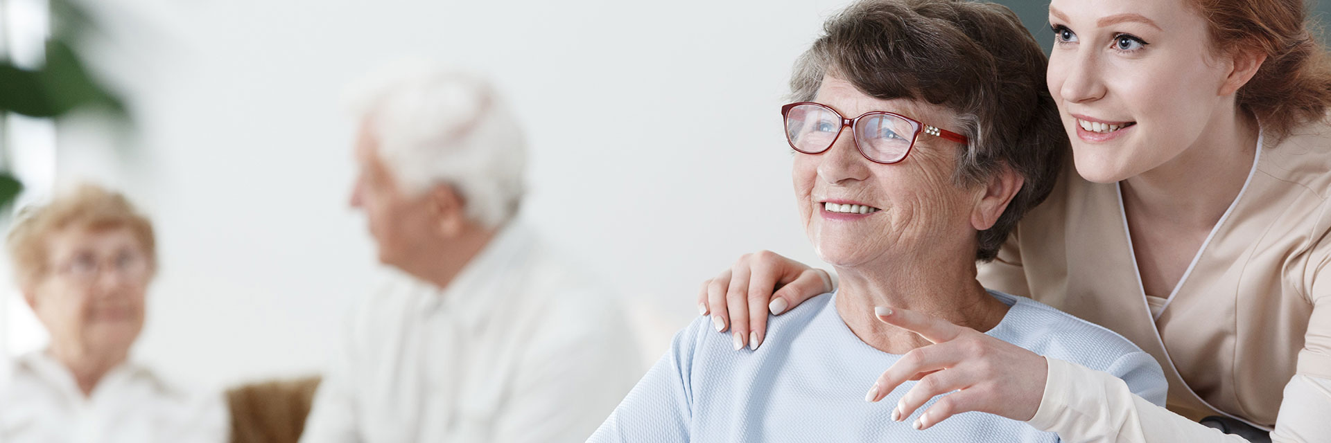 Happy older woman with relative in nursing home